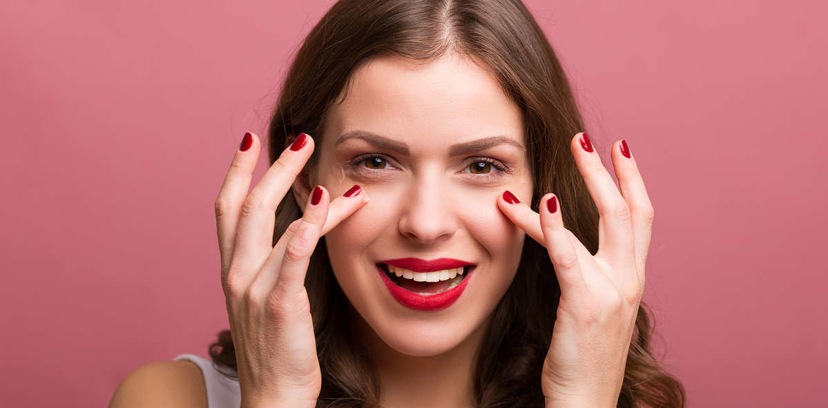 woman applying serum to face