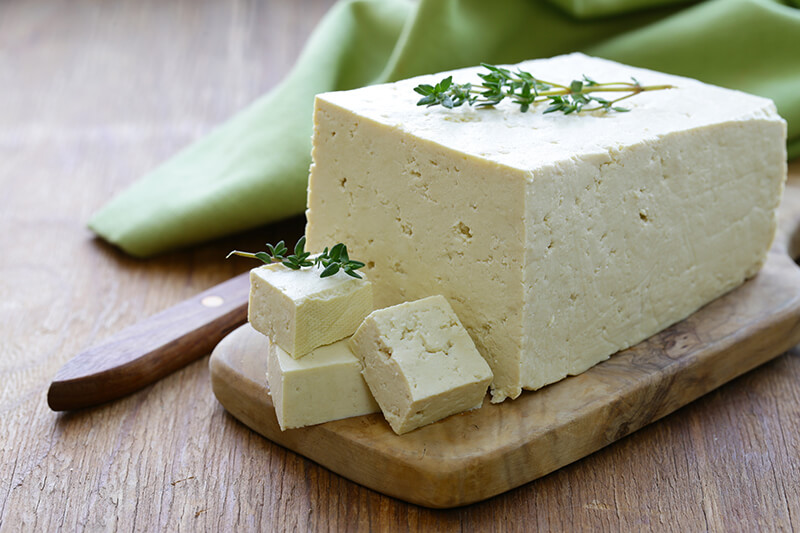 block of tofu on a cutting board